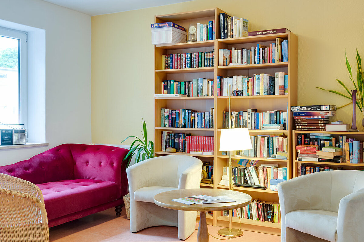 Gemeinschaftsraum mit Sofa und Bücherregal